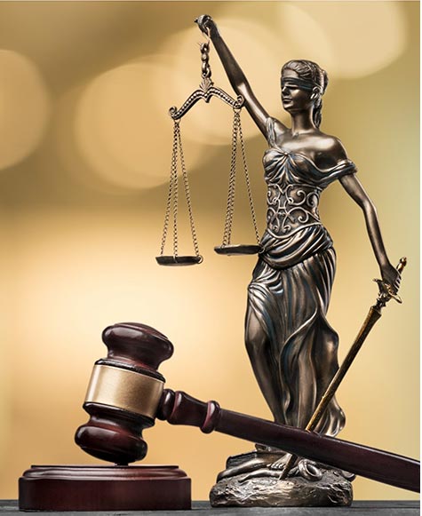 Picture of a blindfolded lady justice holding a sword in her left hand and a large scale in her right hand.